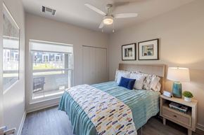 Wichita apartment for rent - A bedroom with a bed, nightstand, and window.