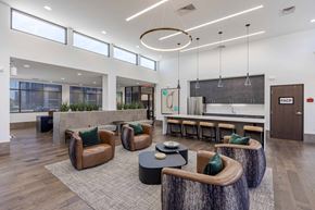 Wichita apartment for rent - A modern office space with brown leather chairs and a wooden coffee table.