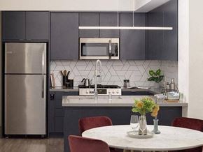 Long Beach apartment for rent - A modern kitchen with a stainless steel refrigerator and a white countertop.