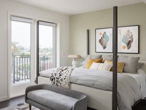 Long Beach apartment for rent - A bedroom with a large bed and a balcony with a view of the outside.
