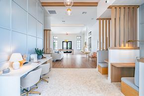 Austin apartment for rent - A modern office space with white furniture and wooden accents.