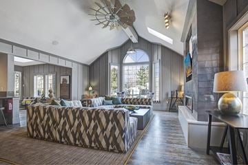 Lakewood apartment for rent - A living room with a patterned sofa and a wooden floor.