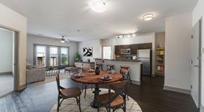 Atlanta apartment for rent - A modern dining room with a wooden table and chairs.