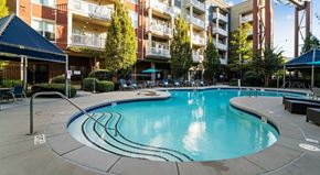 Atlanta apartment for rent - A swimming pool in a courtyard surrounded by buildings.