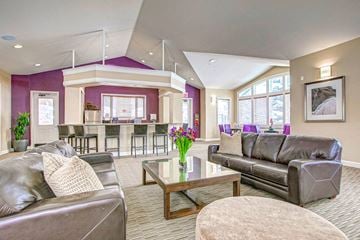 Highlands Ranch apartment for rent - A living room with a brown leather couch and a glass coffee table.