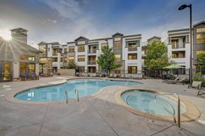 Farmington apartment for rent - A large swimming pool in front of apartment buildings.