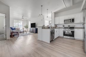 Farmington apartment for rent - A modern kitchen with white cabinets and stainless steel appliances.