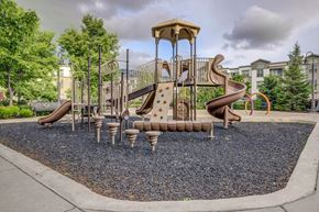Farmington apartment for rent - A playground with a brown and tan slide and a brown and tan swing set.