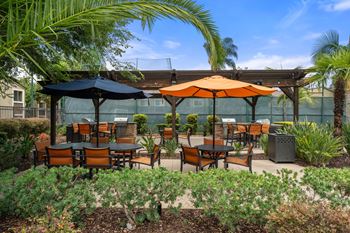 Outdoor kitchen with bbq grills & dining area