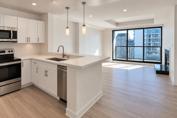 San Francisco apartment for rent - A modern kitchen with white cabinets and a large island.