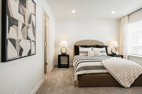 Ogden townhouse for rent - A bedroom with a large bed and a painting on the wall.