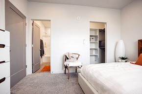 Bluffdale townhouse for rent - A bedroom with a bed, chair, and closet.