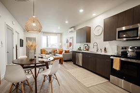 Bluffdale townhouse for rent - A modern kitchen with a dining table and chairs.
