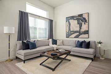 Pleasant Grove townhouse for rent - A living room with a grey couch, a coffee table, and a painting on the wall.