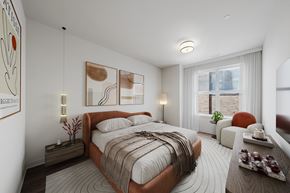 Hackensack apartment for rent - A bedroom with a large bed and a window with blinds.