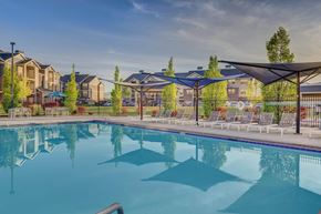 West Valley City apartment for rent - A large swimming pool in front of a resort.