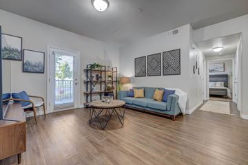 West Valley City apartment for rent - A living room with a blue couch and a wooden coffee table.