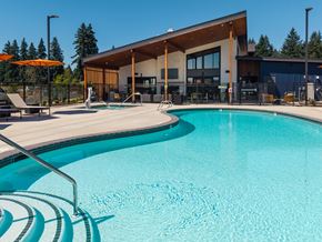 Vancouver apartment for rent - A swimming pool in front of a building with a person standing in the background.