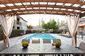 Pleasanton apartment for rent - Dog-Friendly Apartments in Pleasanton, CA - Civic Square - Pool with a Wooden Cabana, Seating Area, and Lounge Chairs