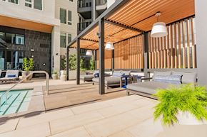 Burlingame apartment for rent - A modern outdoor seating area with a pool and lounge chairs.