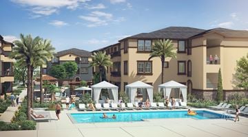 Anaheim apartment for rent - A swimming pool surrounded by palm trees and lounge chairs.