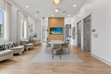 Hutto apartment for rent - A modern living room with a large painting on the wall and a grey sofa.