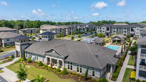 Charlotte apartment for rent - A large house with a pool in the front yard of a residential area.