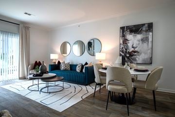 Littleton apartment for rent - A living room with a blue couch and a white table.