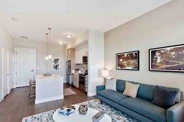 Medford apartment for rent - A living room with a blue couch and a coffee table.
