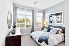 Medford apartment for rent - A bedroom with a large bed and a window with blinds.