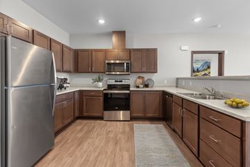 Spokane apartment for rent - A modern kitchen with wooden cabinets and stainless steel appliances.