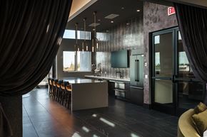 Mountain View apartment for rent - a kitchen with a long counter and chairs and a glass door