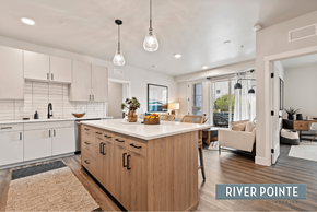 Boise apartment for rent - A modern kitchen with wooden cabinets and a central island.