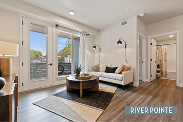 Boise apartment for rent - A living room with a white couch and a coffee table in the middle.