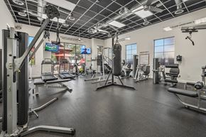 Phoenix apartment for rent - A gym with a variety of equipment including a punching bag.