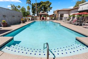 Phoenix apartment for rent - A swimming pool with a metal ladder in the middle.