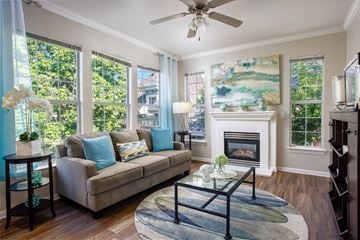 Lakewood apartment for rent - A living room with a couch, a fireplace, and a painting on the wall.