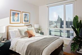 Hillsboro apartment for rent - A bedroom with a large bed and two framed pictures on the wall.