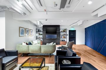 Denver apartment for rent - A living room with a green couch and a television.