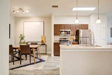 Colorado Springs apartment for rent - A modern kitchen with a dining table and chairs.