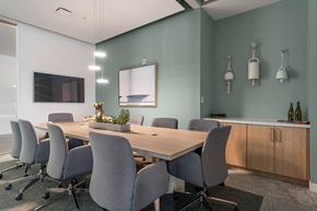 Phoenix apartment for rent - A conference room with a long table and grey chairs.