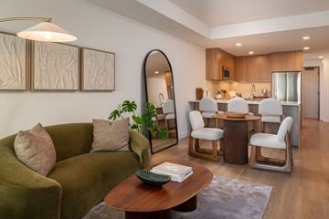 San Diego apartment for rent - A living room with a green couch and a wooden coffee table.