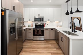 Nashville apartment for rent - a kitchen with white cabinets and stainless steel appliances