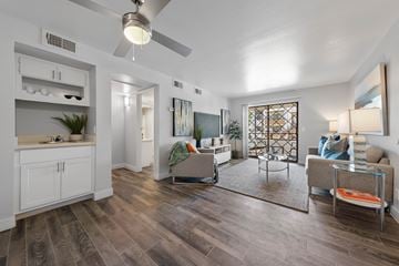 Mesa apartment for rent - A living room with a grey sofa and a glass coffee table.