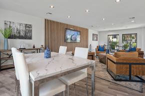 Mesa apartment for rent - A modern dining room with a white marble table and chairs.