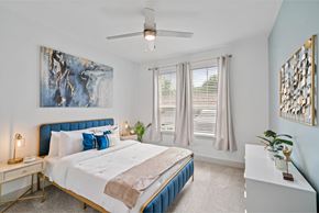 Katy apartment for rent - A bedroom with a large bed and a ceiling fan.