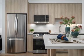 Phoenix apartment for rent - A modern kitchen with a stainless steel refrigerator and a white countertop.