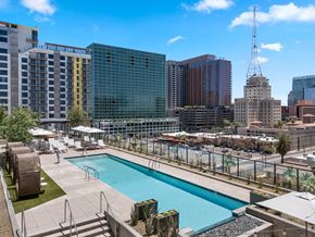 Phoenix apartment for rent - A pool area with a view of the city skyline.