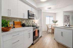 Chandler apartment for rent - a kitchen with white cabinets and stainless steel appliances