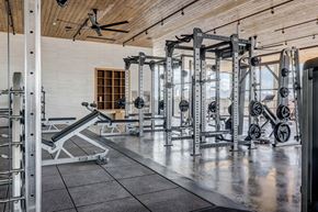 Lehi apartment for rent - A gym with a variety of weightlifting equipment.
